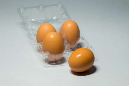 fresh chicken egg in plastic packaging on white background.