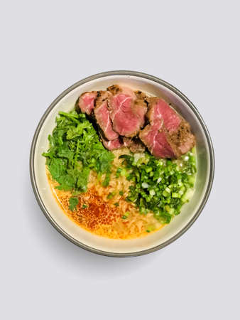 bowl of white rice, stair fried of vegetables and rare grill beef steak on white background.