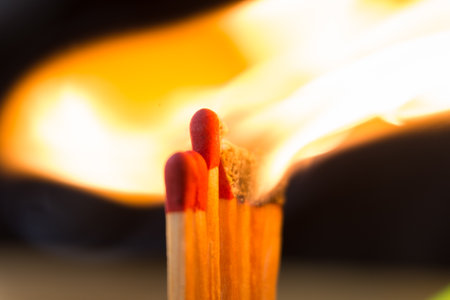 close up the line of matchstick be on fire make a big flame in dark background.の写真素材