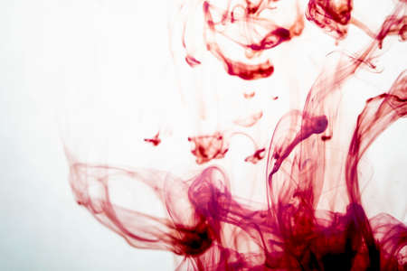 selective soft focus red liquid like blood drop in to clear waterの写真素材