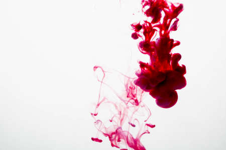 selective soft focus red liquid like blood drop in to clear waterの写真素材