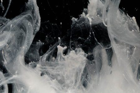close up of white ink in water on black background, abstract backgroundの写真素材