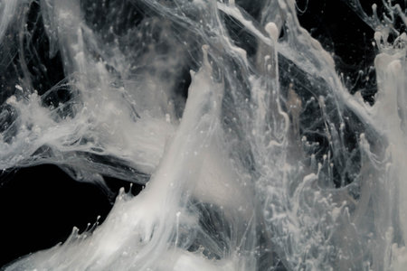 close up of white acrylic paint splash isolated on black background, abstract backgroundの写真素材