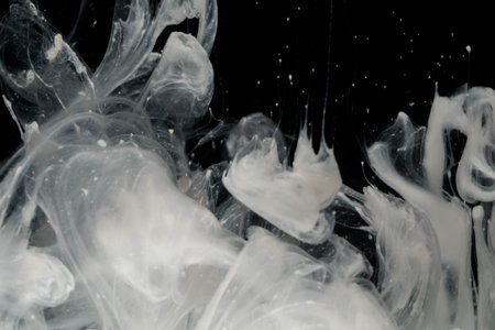 Abstract paint splash isolated on black background. Ink drop in water.の写真素材