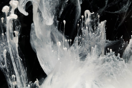 Abstract paint splash isolated on black background. Acrylic ink in water. selective focus.の写真素材