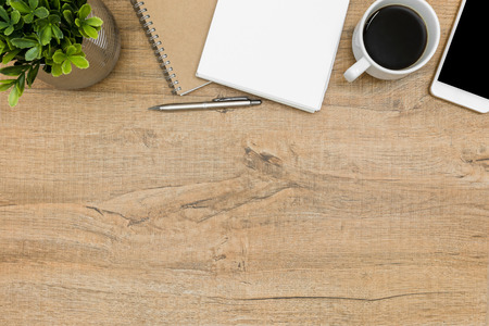 Wood student desk with notebook, pen, coffee and supplies. Top view with copy space, flat lay.の写真素材