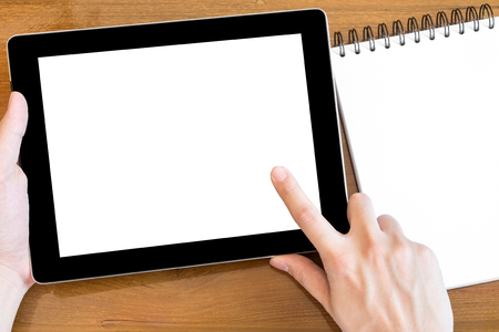 Man is touching the tablet with white mockup screen.の写真素材