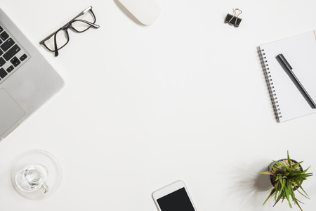 White office desk table with laptop and supplies. Top view with copy space, flat lay.の写真素材