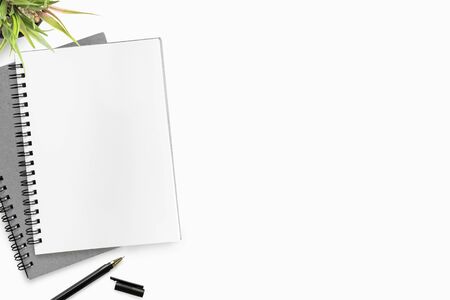 Blank notebook page is on top of white office desk table with pen Top view, flat lay.の写真素材