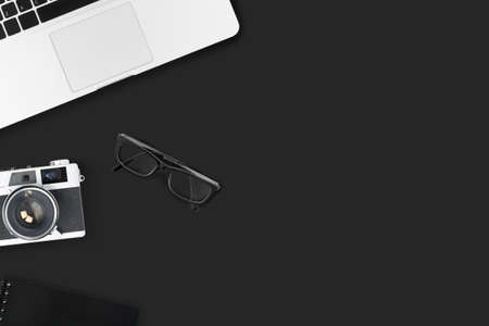 Black photo grapher office desk table with camera and supplies. Top view with copy space, flat lay.の写真素材