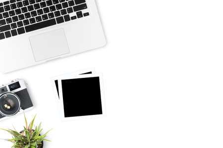 Film camera with blank picture frames are on top of white table.の写真素材