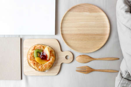 Dish of mixed fruits pies is on top of the bed. Breakfast in bed concept. Top view, flat lay.の写真素材