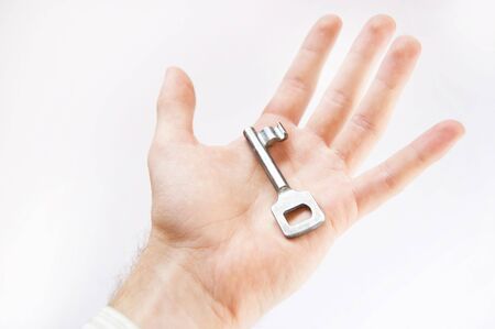 Key conceptual image. Man holds the key.の写真素材