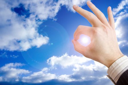 Success in business conceptual image. Businessman hand against the blue sky.の写真素材