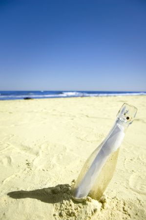 Message conceptual image. Message in a bottle on sand.の写真素材