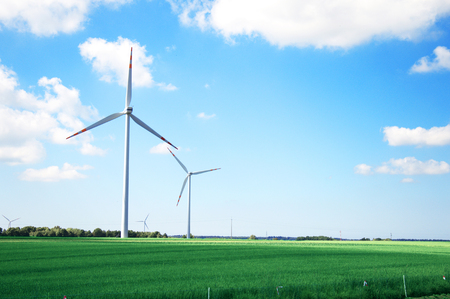 Windmill conceptual image  Windmills on the green field 