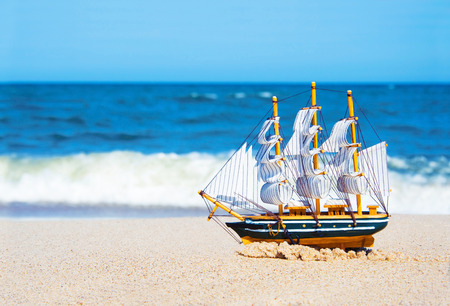 Model of a ship floats on the beach. Vacation conceptual image.の写真素材