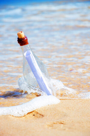 Bottle with a message. Beach and ocean.の写真素材