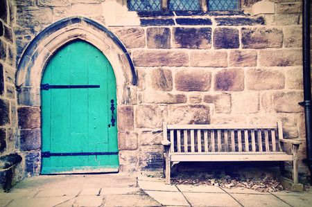 Old doors and bench in creamy pastel vintage picture.の写真素材