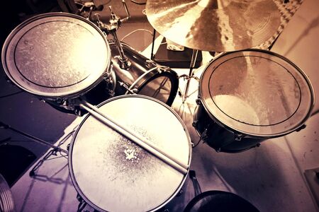 Drums conceptual image. Picture of drums and drumsticks lying on snare drum. 