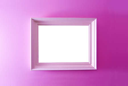 White empty frame on the pink wall. Free copy space.の写真素材