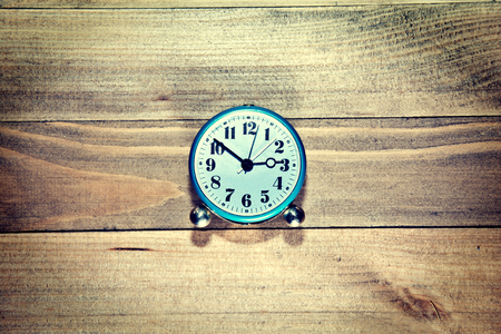 Old clock on the wooden background. Retro vintage picture. Time concept.の写真素材