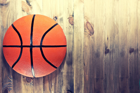 Basketball ball on wooden hardwood floor in the basketball court. Retro vintage picture. Sport concept.の写真素材