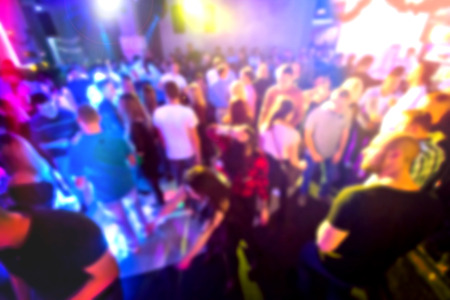 Crowd of people on the club party. Motion blurred picture.の写真素材