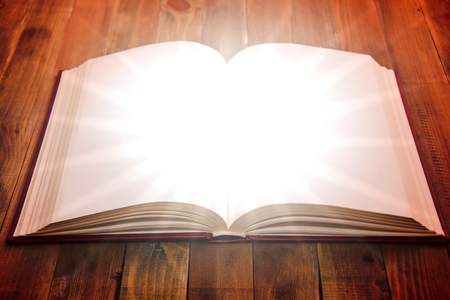 Open book on wooden table. Knowledge and education conceptual image.の写真素材