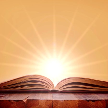 Open book on wooden table. Knowledge and education conceptual image.