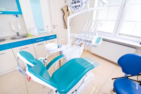 Professional Dentist tools and chair in the dental office. Dental Hygiene and Health conceptual image.の写真素材