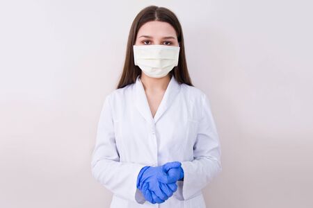 Female doctor wearing protection face mask and gloves. Covid-19 concept.の写真素材