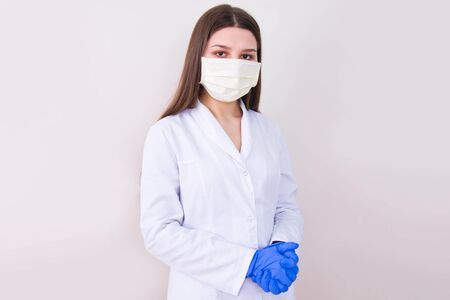 Female doctor wearing protection face mask and gloves. Covid-19 concept.の写真素材