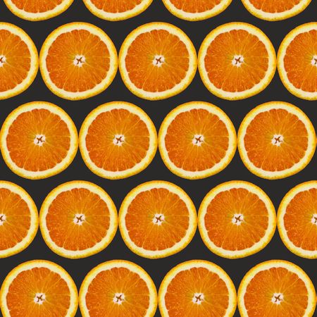 Creative pattern made of orange on black background. Food conceptの写真素材