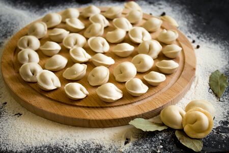 Uncooked Russian homemade dumplings or ravioli on the Board. The view from the topの写真素材