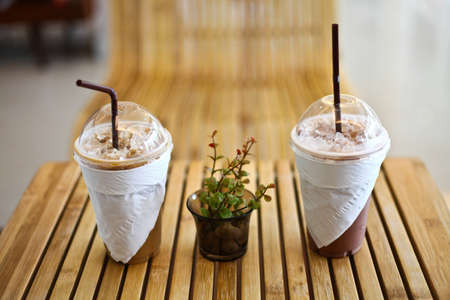 Ice coffee and ice cocoa on wood table の写真素材