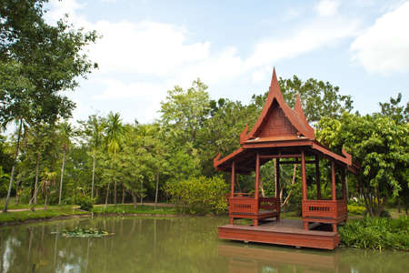 Old thai house style in garden with water のeditorial素材