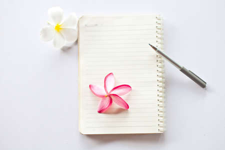 Notebook and pen with flower の写真素材