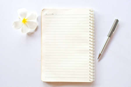 Notebook with pen and flower 