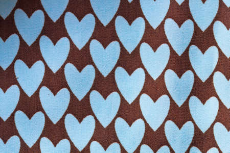 Close up blue heart on brown cotton texture の写真素材