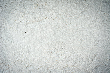 Texture of old rustic wall covered with white stucco. Abstract background for design.の写真素材