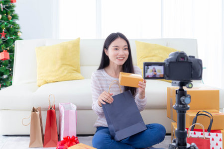 Happy asian woman recording content for her lifestyle blog vlog. Business online and social media concept.の写真素材