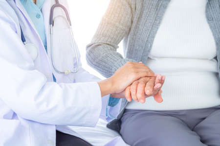 Doctor holding touching hands Asian senior or elderly old lady womanの写真素材