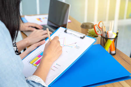 Close up of business document on the desk, Analysis charts, Financial charts. Business people in...