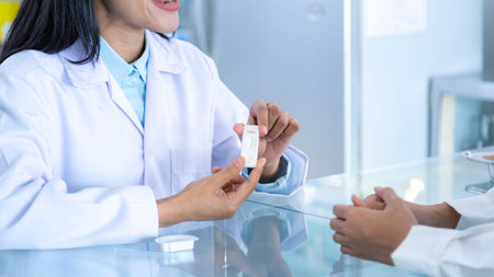 Pharmacist or doctor explaining how to use the pregnancy test sticks to female customers.の写真素材