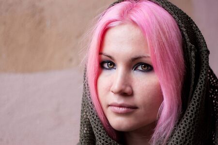 We see young beauty woman with pink hair with scarf on her head