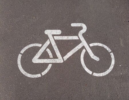 White bicycle road sign painted on asphaltの写真素材