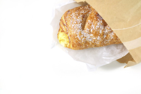 sweet bread in paper bag on white backgroundの写真素材