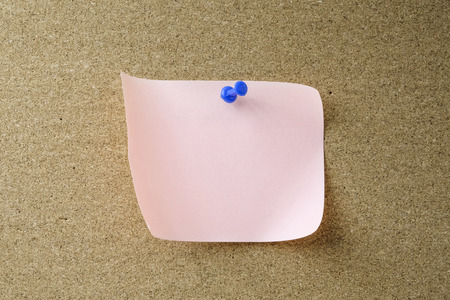 Stick note on wooden background
