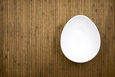 white bowl on wooden backgroundの写真素材